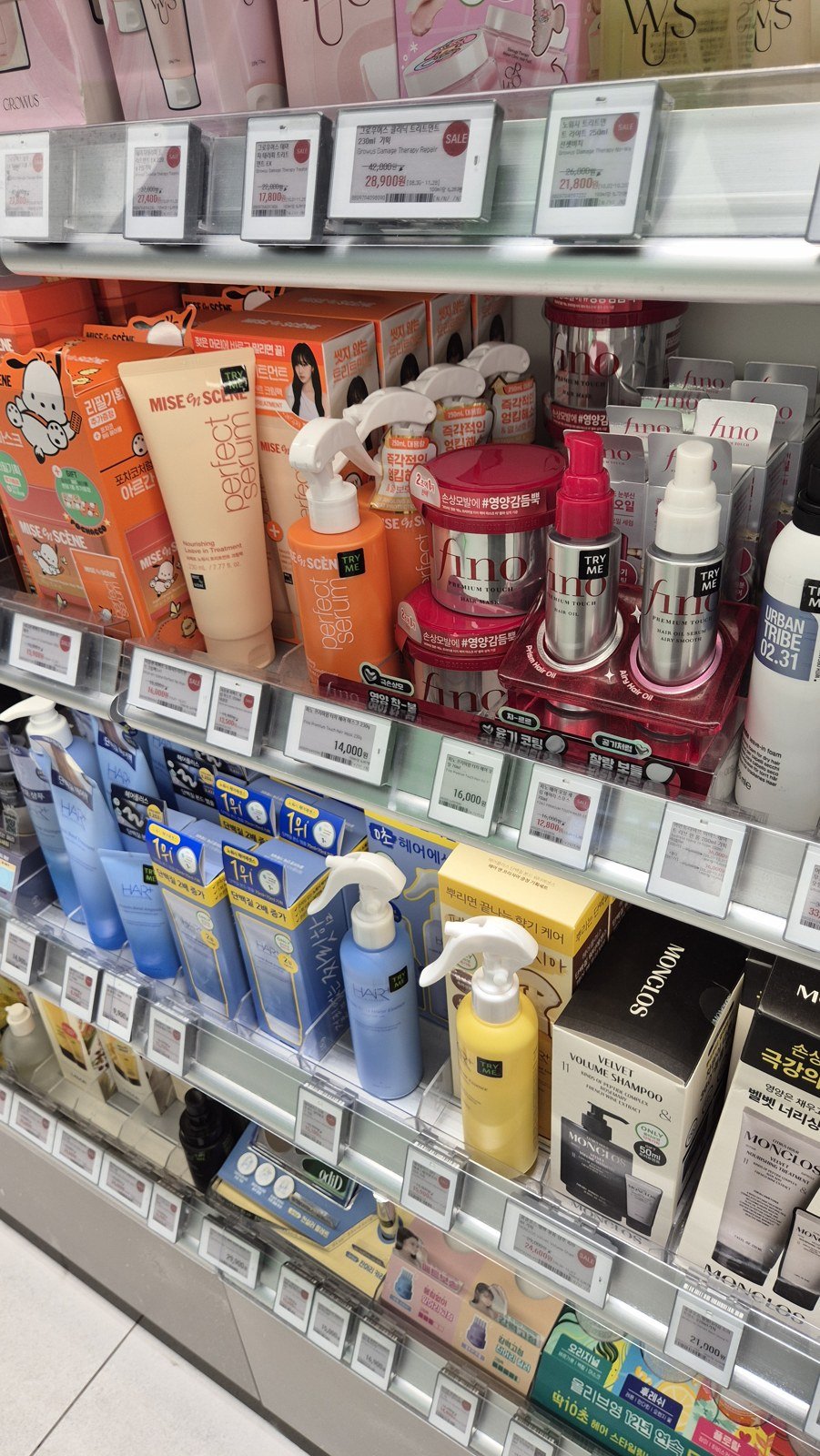 Mise-en-scène leave-in treatment and Fino hair masks and oils displayed at Olive Young